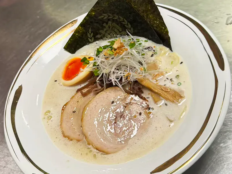 Rich creamy tonkotsu ramen with tender chashu & marinated egg at Koi Sushi, a Japanese Restaurant in Gaithersburg