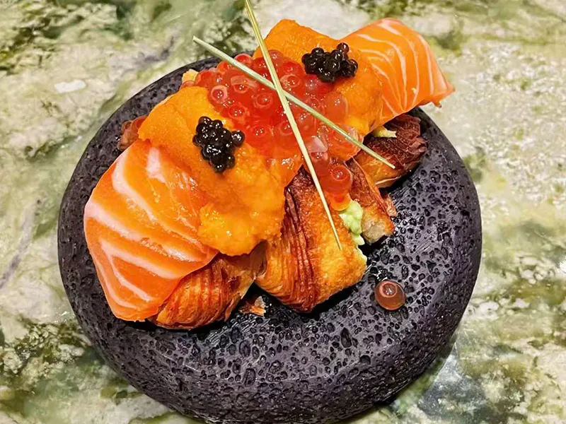 Decadent croissant stack with salmon, uni, ikura & caviar at Koi Sushi, a Japanese Restaurant in Gaithersburg